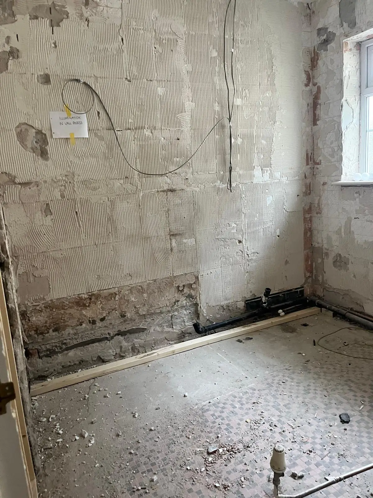 Bathroom stripped back to bare walls and floor before the refurbishment