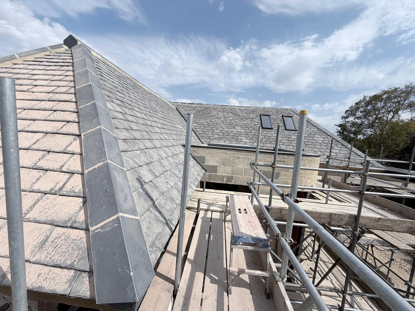 Completed slate hip roof with new blockwork and rooflights beyond