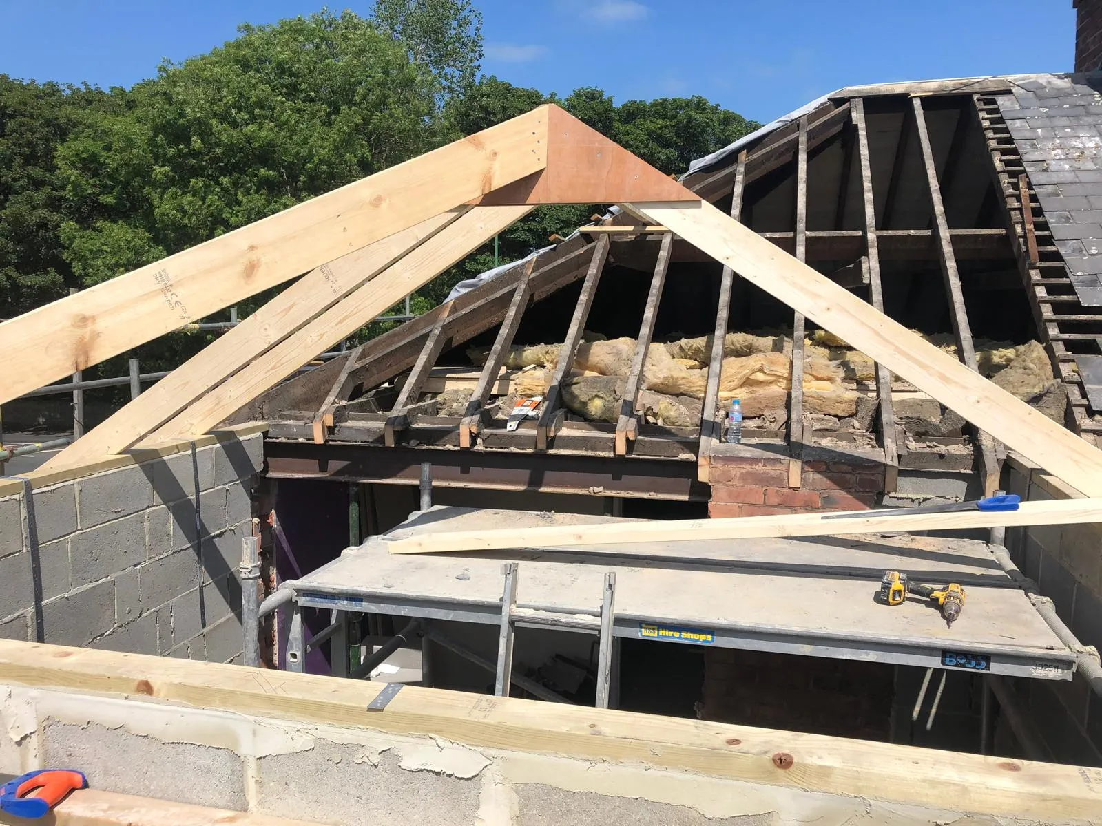 First timbers of the new hipped roof going up against the existing roof