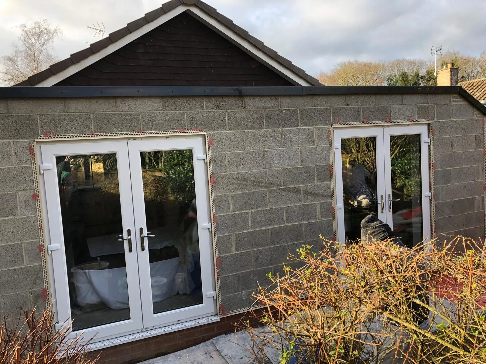 Blockwork extension walls with render beads fitted around French doors
