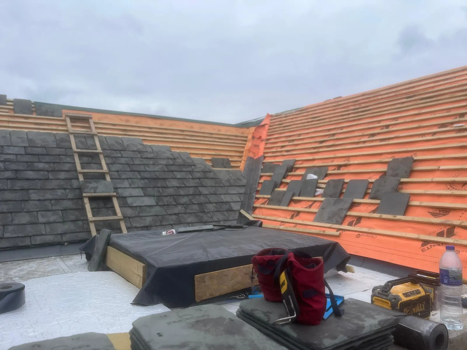 Slating underway beside a new flat roof deck